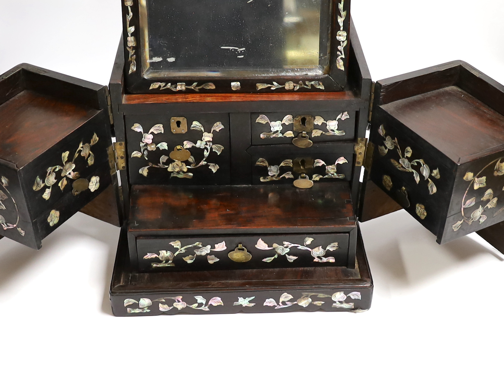 A Chinese mother-of- pearl inlaid hongmu vanity cabinet, late Qing dynasty, with fitted interior comprising a mirror, drawers, etc. 24cm x 31cm x 20cm